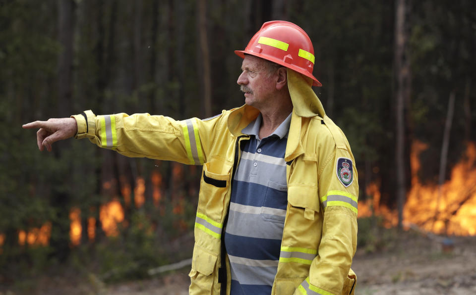Doug Schutz, the Tomerong Rural Fire Service Captain, oversees a controlled burn near Tomerong, Australia, Wednesday, Jan. 8, 2020, set in an effort to contain a larger fire nearby. Schutz began volunteering with the Rural Fire Service in New South Wales some 53 years ago, at the age of 13. That was back in the days when the fire truck was a Land Rover that towed a trailer with a water pump on top. Schutz is part of an army of 72,000 people from across the state who make up the world's largest volunteer fire service. (AP Photo/Rick Rycroft)
