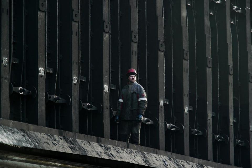 A Ukrainian worker walks at a coking plant in Avdiivka, Ukraine, Tuesday, Jan. 31, 2017. Fighting between government troops and Russia-backed separatist rebels in eastern Ukraine escalated on Tuesday, killing at least eight people late Monday and early Tuesday, injuring dozens and briefly trapping more than 200 coal miners underground, the warring sides reported.(AP Photo/Inna Varenytsia)