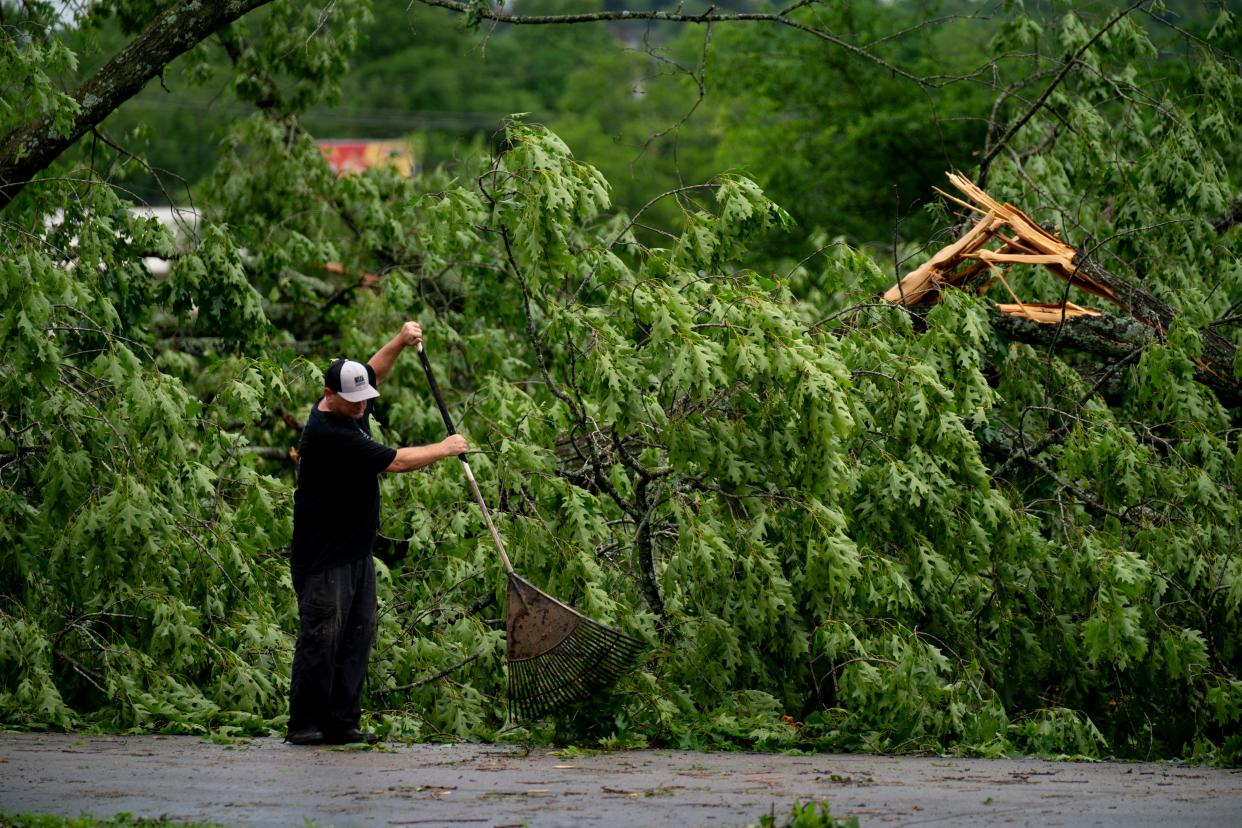Aaron White, an employee at Starstruck Farms in Gallatin, Tenn., cleans up debris after storms hit the area Wednesday afternoon throughout Thursday morning at in Gallatin, Tenn., Thursday, May 9, 2024.