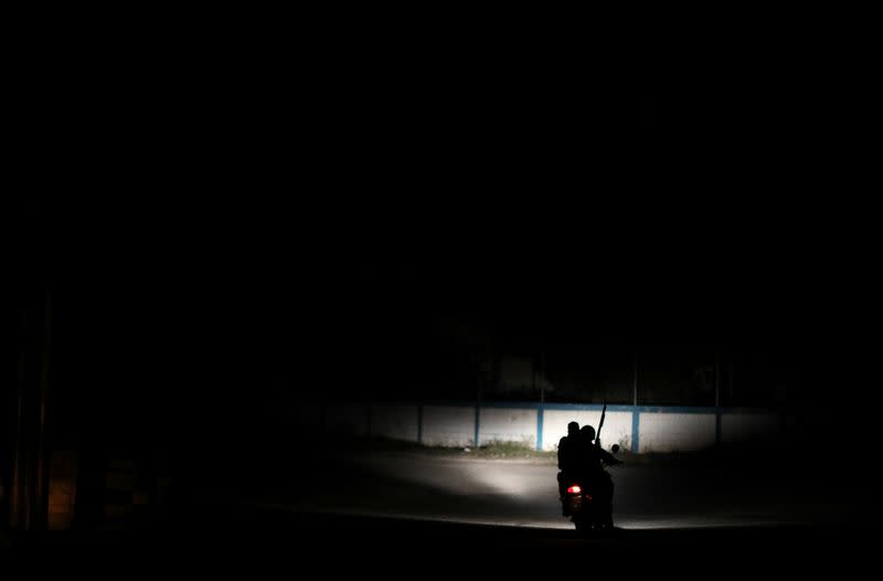 Members of the Special Action Force of the Venezuelan National Police (FAES) ride on a motorcycle in a neighbourhood, in Barquisimeto