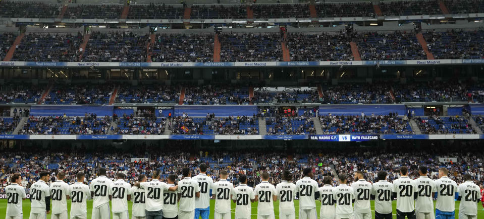 Players of Real Madrid wear jerseys with the name of team mate Vinicius Junior for a Spanish La Liga soccer match between Real Madrid and Rayo Vallecano at the Santiago Bernabeu stadium in Madrid, Spain, Wednesday, May 24, 2023. (AP Photo/Manu Fernandez)