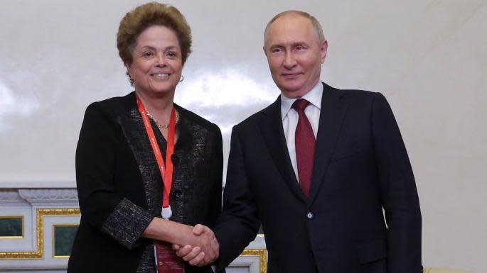 Russia's President Vladimir Putin shakes hands with President of the New Development Bank (NDB) Dilma Rousseff during a meeting on the sidelines of the St Petersburg International Economic Forum on 6 June 2024