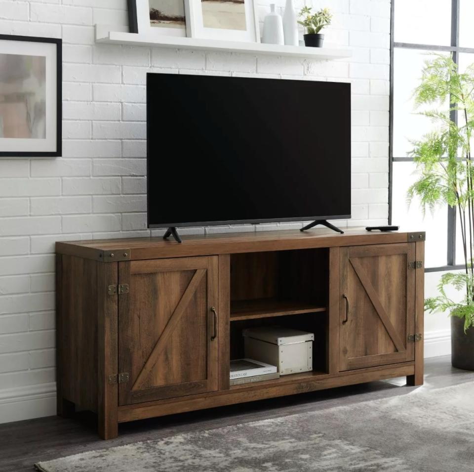 The farmhouse barn door TV stand in rustic oak