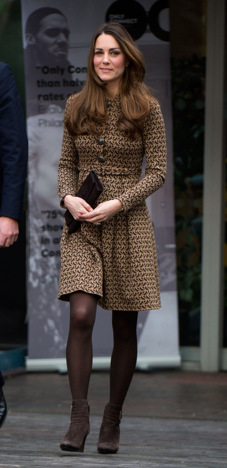 <p>For a charity visit, Kate wore a printed Orla Kiely dress with brown Aquatalia heeled boots and a matching clutch. </p><p><i>[Photo: PA]</i></p>