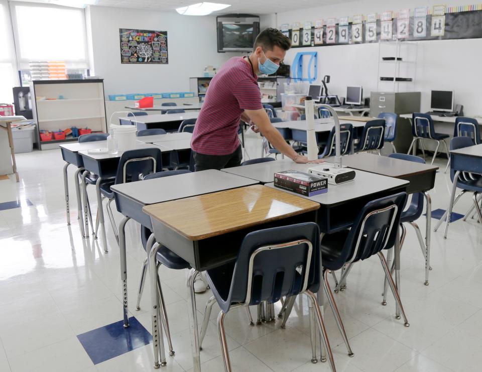 Earlier this summer, teachers at Woodcrest Elementary School, including Michael Menendez, a fifth-grade math and science teacher, prepared their classrooms for the first day of school at the year-round school.