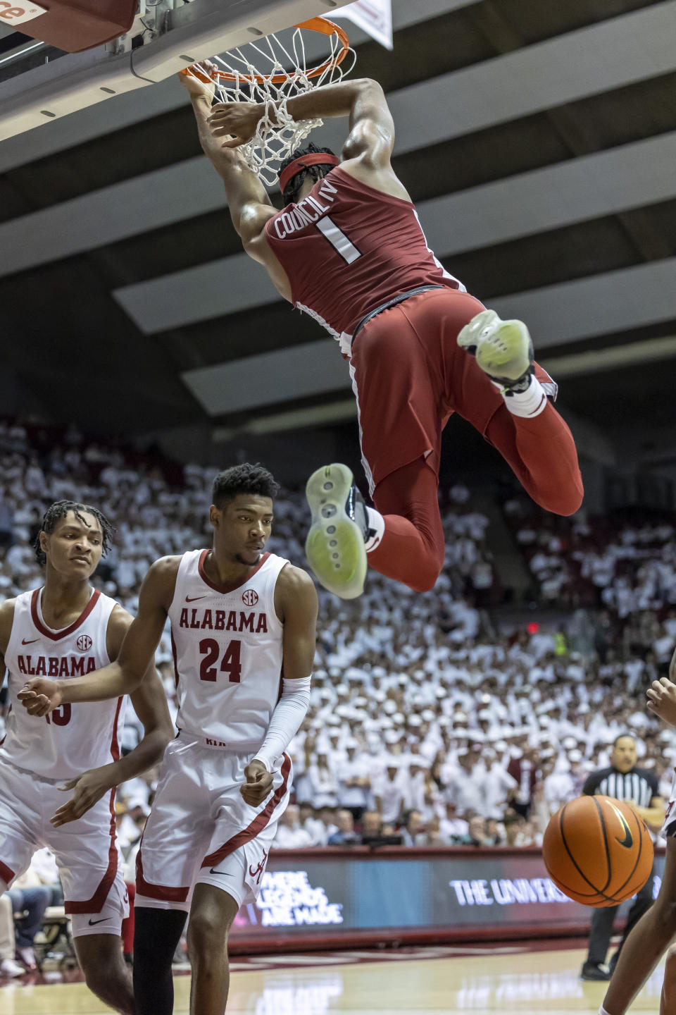 Arkansas guard Ricky Council IV (1) dunks over Alabama forward Noah Clowney (15) and forward Brandon Miller (24) during the first half of an NCAA college basketball game, Saturday, Feb. 25, 2023, in Tuscaloosa, Ala. (AP Photo/Vasha Hunt)