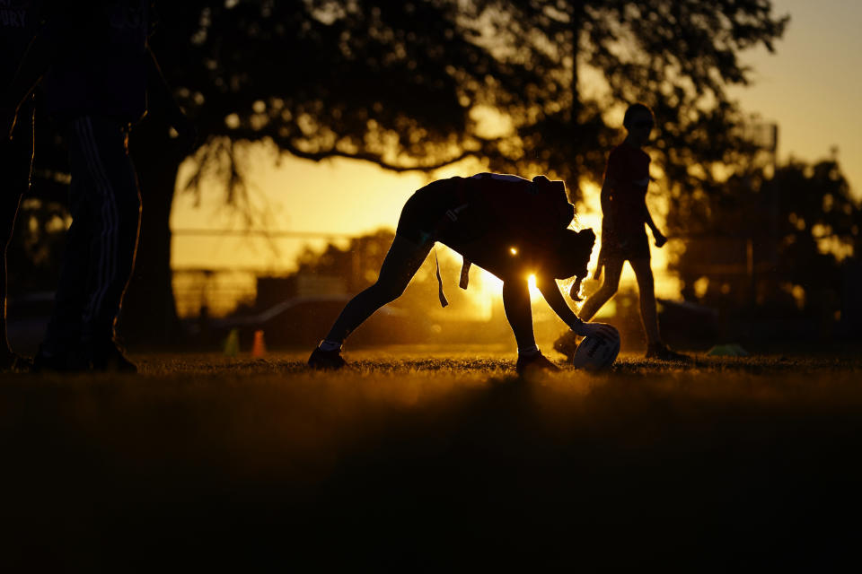 A player prepares to snap the ball during a practice with Texas Fury, an all-girls flag football select travel team, Sunday, Dec. 10, 2023, in Austin, Texas. Flag football's inclusion in the 2028 Summer Olympics in Los Angeles only enhances the profile of a sport that's growing by leaps and bounds on the women's side. (AP Photo/Eric Gay)