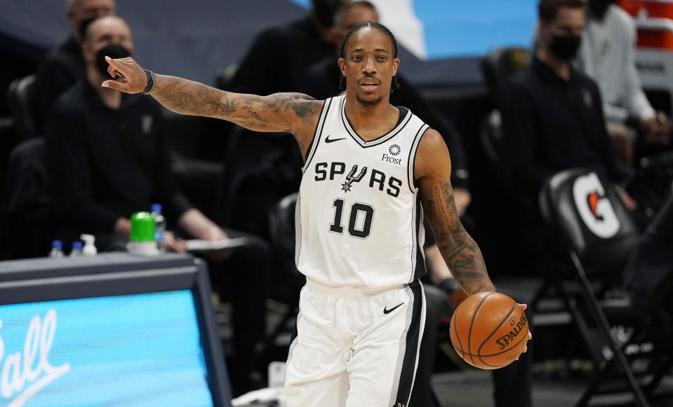 San Antonio Spurs forward DeMar DeRozan directs his teammates in the first half of an NBA basketball game against the Denver Nuggets, Friday, April 9, 2021, in Denver. (AP Photo/David Zalubowski)