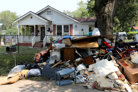 FILE PHOTO: Flood damage from a home is left along the street in the aftermath of tropical storm Harvey in Wharton, Texas, U.S., September 6, 2017. REUTERS/Mike Blake/File Photo