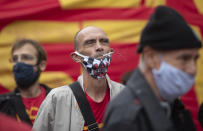 A demonstrator smokes a cigarette during a protest against Brazil's President Jair Bolsonaro and his handling of the new coronavirus pandemic in Sao Paulo, Brazil, Sunday, June 28, 2020. (AP Photo/Andre Penner)