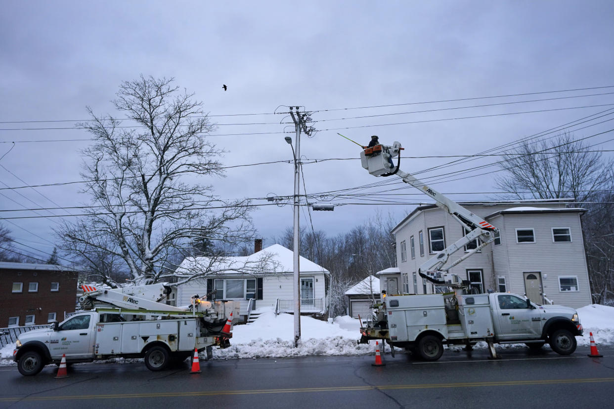Central Maine Power Co. lineman John Baril works to restore electricity, Wednesday, March 15, 2023, in Lewiston, Maine. A late-winter storm dumped heavy, wet snow on parts of the Northeast, causing tens of thousands of power outages. (AP Photo/Robert F. Bukaty)