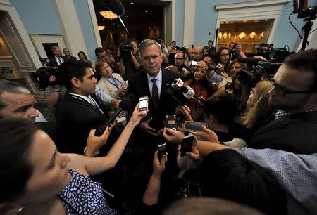 Republican presidential hopeful Jeb Bush, the former governor of Florida, talks to a throng of media personnel after addressing an economic summit hosted by Florida Gov. Rick Scott in Orlando, Florida, June 2, 2015. REUTERS/Steve Nesius