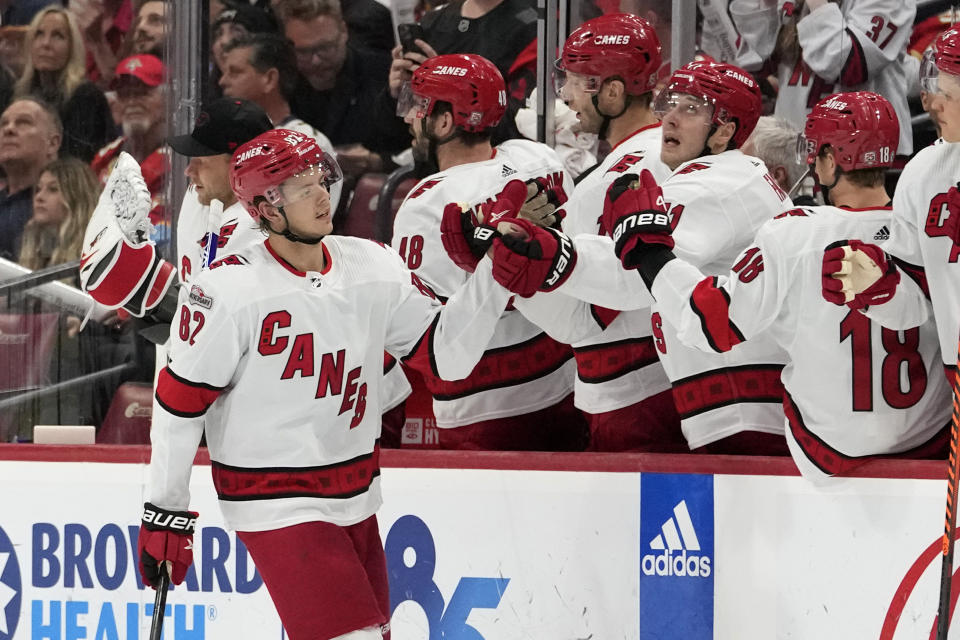 Carolina Hurricanes center Jesperi Kotkaniemi (82) is congratulated for his goal against the Florida Panthers during the second period of an NHL hockey game Thursday, April 13, 2023, in Sunrise, Fla. (AP Photo/Lynne Sladky)