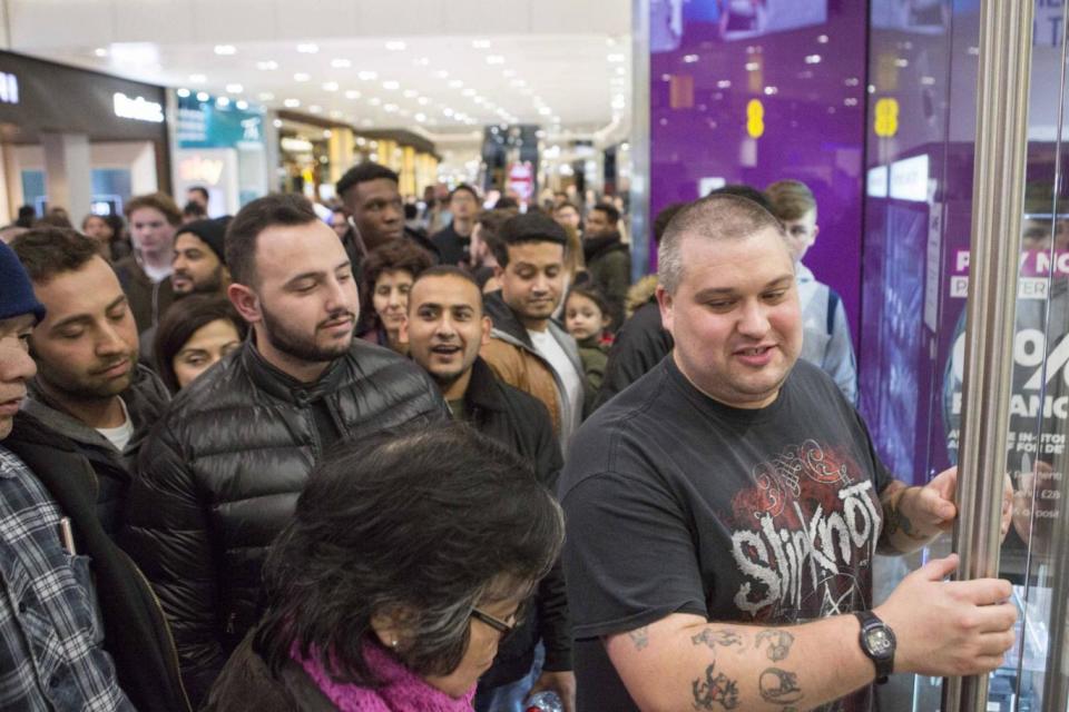 Bargain-hunters queue up outside GAME in Westfield shopping centre, Stratford, on Thursday evening (PA)