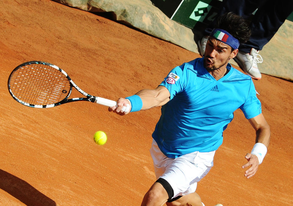 Italy's Fabio Fognini returns a ball to Britain's Andy Murray during a Davis Cup World Group quarterfinal match in Naples, Italy, Sunday, April 6, 2014. (AP Photo/Salvatore Laporta)