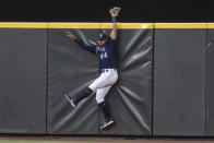 Seattle Mariners centerfielder Julio Rodriguez hits the outfield wall after failing to catch a home run ball hit by Baltimore Orioles' Jorge Mateo during the sixth inning of a baseball game, Monday, June 27, 2022, in Seattle. (AP Photo/Stephen Brashear)