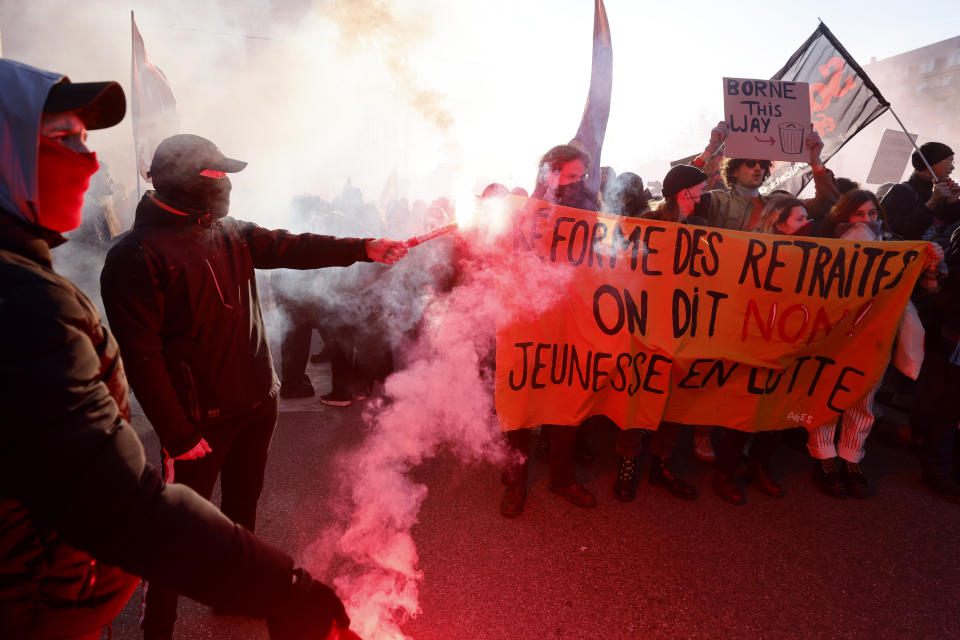 Demonstrators hold a banner reading "Retirement Reform, We Say No, Youth in Struggle" during a march against pension reforms in Strasbourg, eastern France, Tuesday, Feb. 7, 2023. Public transportation, schools and electricity, oil and gas supplies were disrupted on Tuesday in France as demonstrators were taking to the streets for a third round of nationwide strikes and protests against the government's pension reform plans. (AP Photo/Jean Francois Badias)