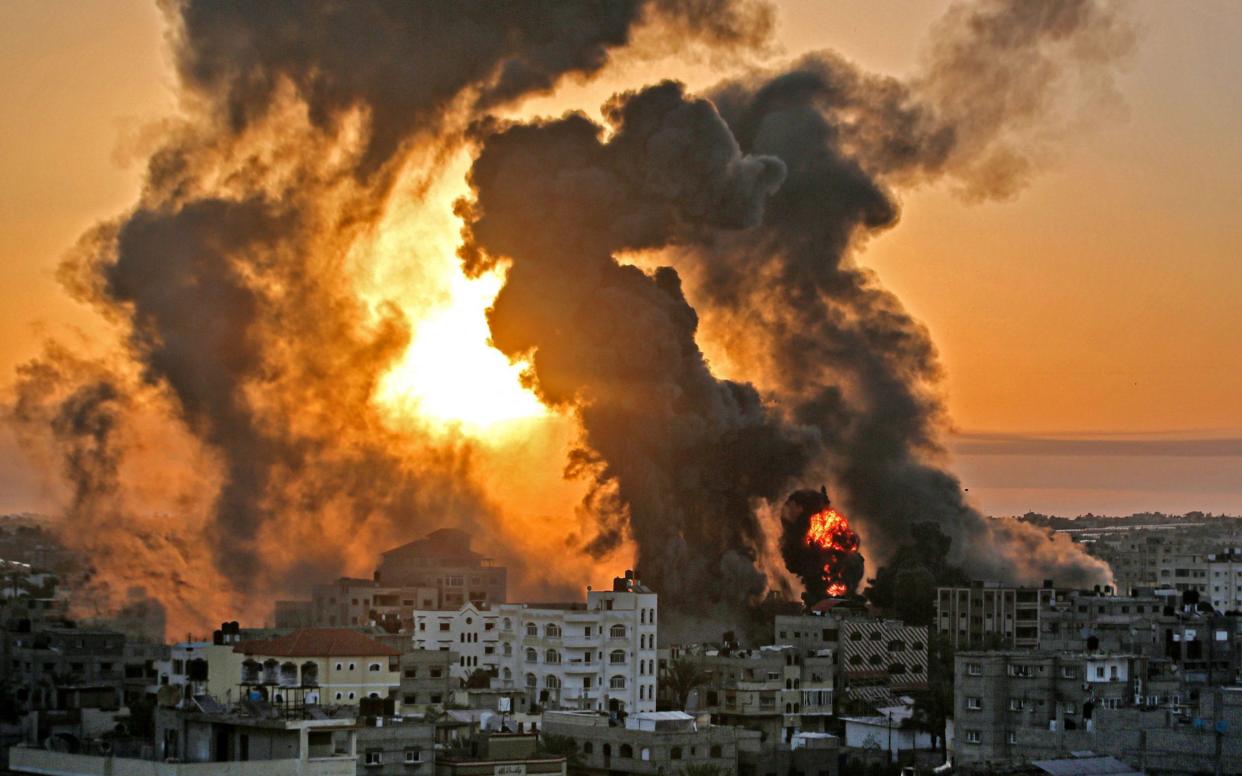 A fire rages at sunrise in Khan Yunish following an Israeli airstrike on targets in the southern Gaza strip - AFP Contributor#AFP 