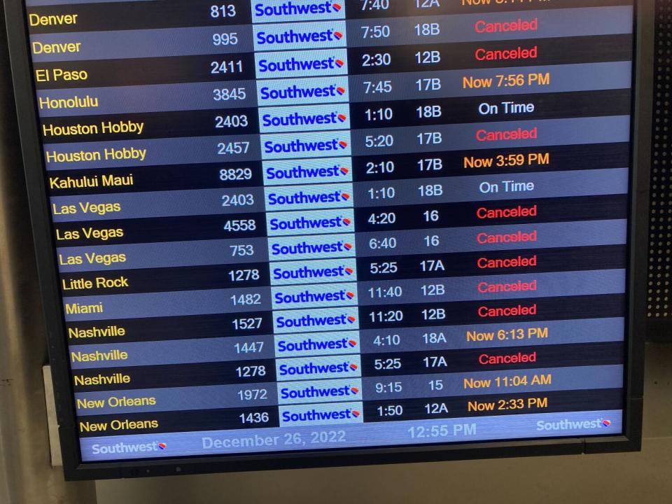 A flight board shows canceled flights at the Southwest Airlines terminal at LAX.