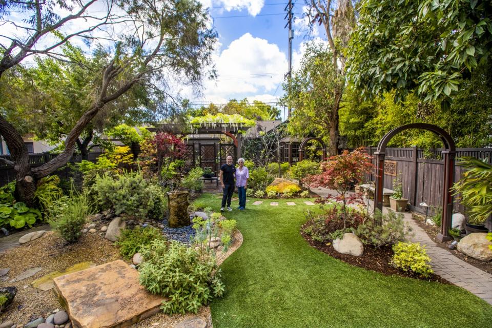 Mike Esparza and his mom, Libby Esparza, in the yard of his Long Beach home.