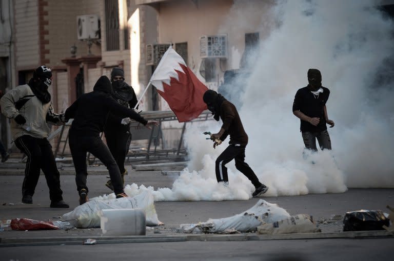 Bahraini protesters run for cover from tear gas during a demonstration to mark the second anniversary of the uprising in the village of Sanabis, west of the capital Manama on February 14, 2013. Bahrain's opposition called a rally near Manama marking the second anniversary of a Shiite-led uprising against the kingdom's Sunni rulers, a day after two people died when protests turned violent