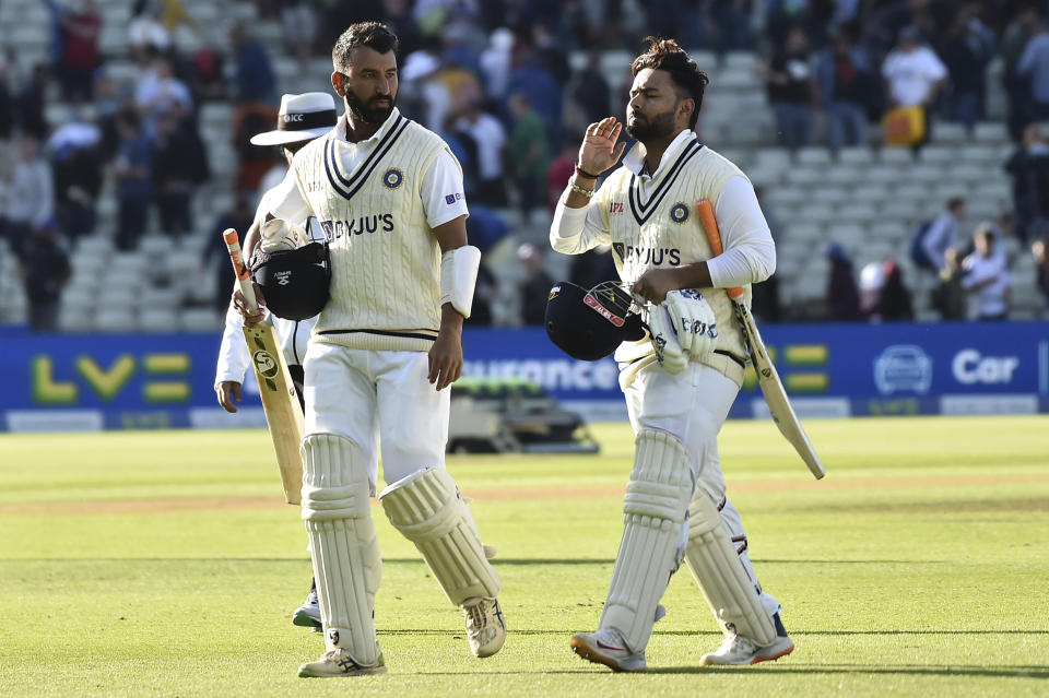 India's Cheteshwar Pujara, left, and India's Rishabh Pant leave the field at the end of play on the third day of the fifth cricket test match between England and India at Edgbaston in Birmingham, England, Sunday, July 3, 2022. (AP Photo/Rui Vieira)