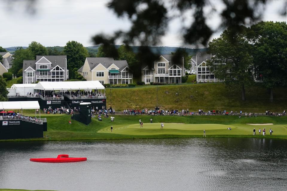 Fans watch competition on the 15th hole during the first round of the Travelers Championship golf tournament at TPC River Highlands, Thursday, June 22, 2023, in Cromwell, Conn. (AP Photo/Frank Franklin II)