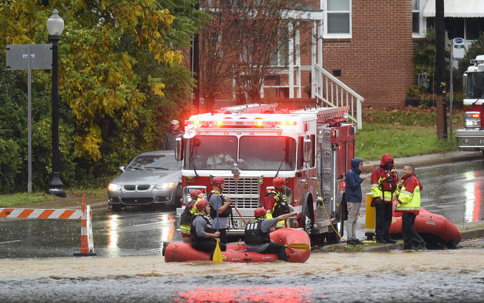 Charlotte Fire water rescue stand at the ready on West Blvd. during a heavy rain in Charlotte, N.C., Thursday, Nov. 12, 2020. Tropical Storm Eta dumped blustery rain across north Florida after landfall Thursday morning north of the heavily populated Tampa Bay area, and then sped out into the Atlantic off of the neighboring coasts of Georgia and the Carolinas. (Jeff Siner/The Charlotte Observer via AP)