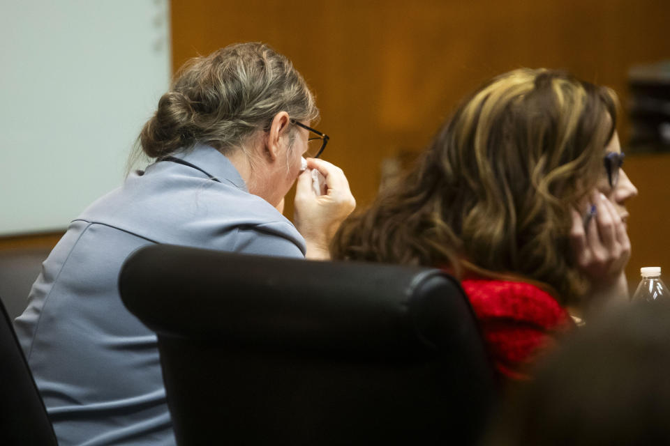 Defendant Jennifer Crumbley, left, wipes tears from her eyes while watching police video of her own arrest in December of 2021 during her jury trial at the Oakland County Courthouse on Wednesday, Jan. 31, 2024, in Pontiac, Mich. Jennifer Crumbley is charged with involuntary manslaughter for gross negligence in connection with her son Ethan Crumbley who shot and killed four classmates at Oxford High School in November 2021. James Crumbley, Ethan's father, is also charged with involuntary manslaughter but will be tried separately. (Katy Kildee/Detroit News via AP, Pool)