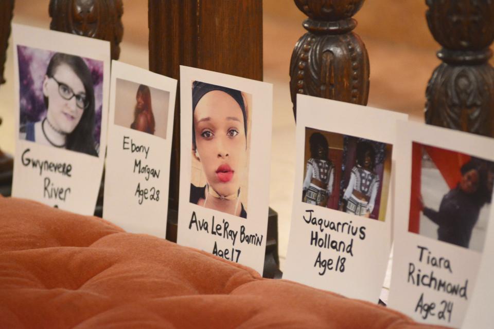 FILE - In this Thursday, Nov. 16, 2017 file photo, pictures of transgender people lost to violence earlier in the year are displayed during a Transgender Day of Remembrance vigil at St. Stephen's Episcopal Church in Pittsfield, Mass. For transgender Americans, 2018 has been marked by series of advancements and setbacks. (Gillian Jones/The Berkshire Eagle via AP)