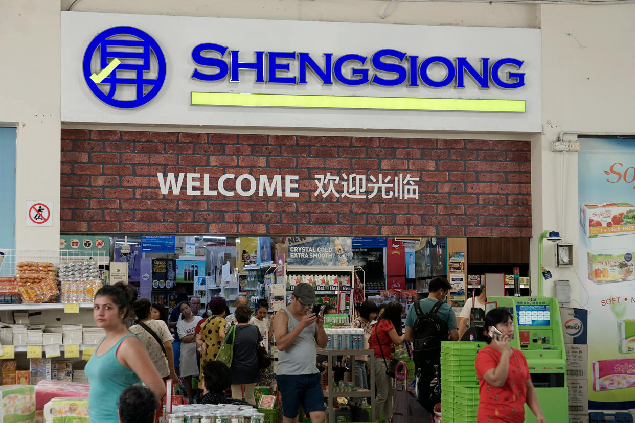 Entrance of a Sheng Siong outlet, showing shoppers milling about. (PHOTO: Yahoo News Singapore file photo)