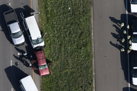 Law enforcement personnel investigate the scene where the Texas bombing suspect blew himself up on the side of a highway north of Austin in Round Rock, Texas, U.S., March 21, 2018. REUTERS/Loren Elliott