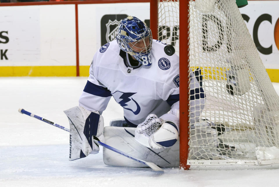 Tampa Bay Lightning goaltender Andrei Vasilevskiy (88) watches as the puck deflects off of the post during the second period of Game 1 of an NHL hockey second-round playoff series against the Florida Panthers Tuesday, May 17, 2022, in Sunrise, Fla. (AP Photo/Reinhold Matay)