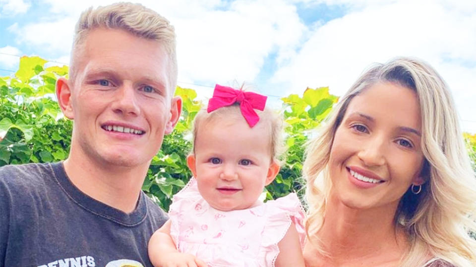 Pictured here, Adam Treloar, partner Kim Ravaillion and their daughter.