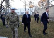 Britain's Foreign Secretary Boris Johnson (C) and British ambassador to Afghanistan Dominic Jermey (R) visit the British cemetery in Kabul, Afghanistan November 26, 2016. REUTERS/Mohammad Ismail