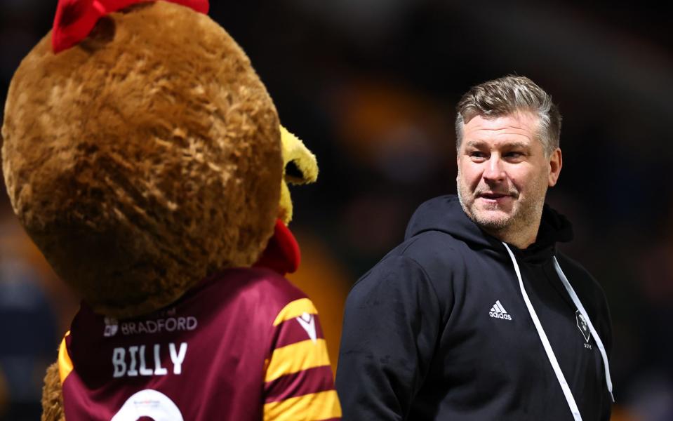 Karl Robinson looks at Billy the Bantam, mascot of Bradford City