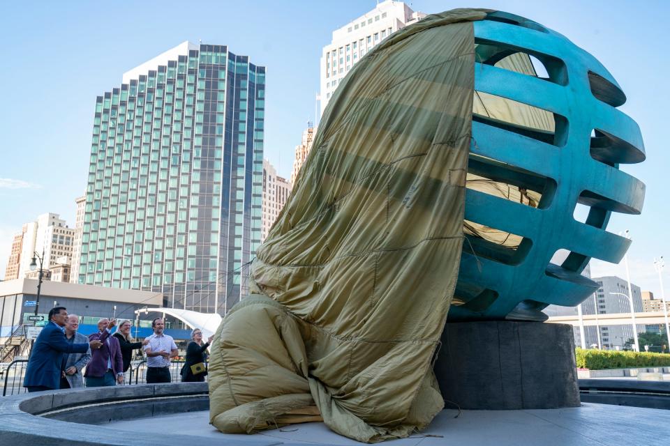 Artist Scott Hocking along with Mayor Mike Duggan and others unveil his sculpture "Floating Citadel" on Wednesday Aug. 17, 2022 in front of Huntington Place.