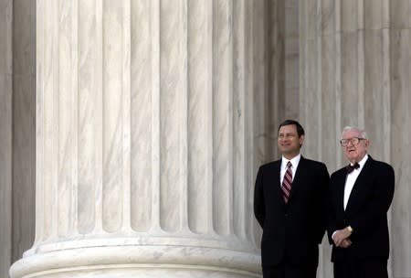 FILE PHOTO: U.S. Chief Justice Roberts stands with Associate Justice Stevens at Supreme Court in Washington