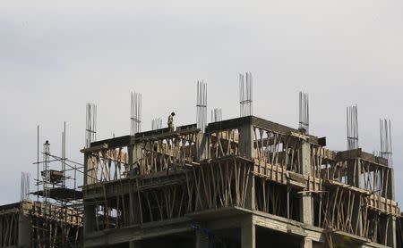 A laborer works on a building construction site in Karachi, Pakistan February 25, 2016. REUTERS/Akhtar Soomro