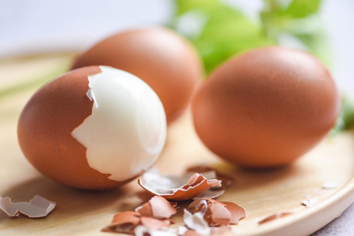 boiled eggs in a wooden plate decorated with leaves