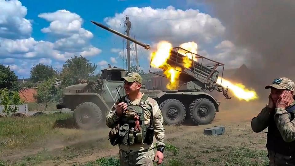 Russian soldiers fire from the BM-21 “Grad” self-propelled 122mm multiple rocket launcher in an undisclosed location in Ukraine (AP)