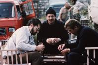 <p>Producer and screenwriter Michael G. Wilson plays backgammon with Israeli actor Chaim Topol and Roger Moore on the set of <em>For Your Eyes Only</em>.</p>