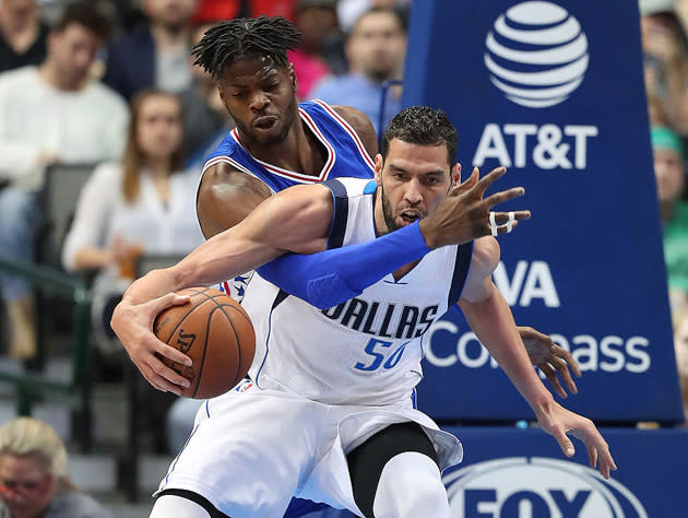 Nerlens Noel tangles with new teammate Salah Mejri. (Getty Images)