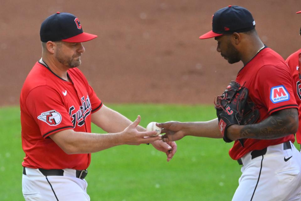 Cleveland Guardians manager Stephen Vogt (12) takes the ball from starting pitcher Xzavion Curry (44) during a pitching change against the New York Mets on May 21 in Cleveland.