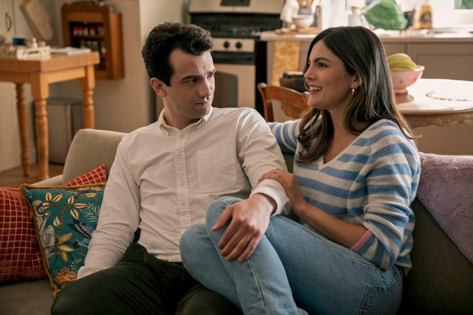 Jay Baruchel holding onto Monica Barbaro's leg