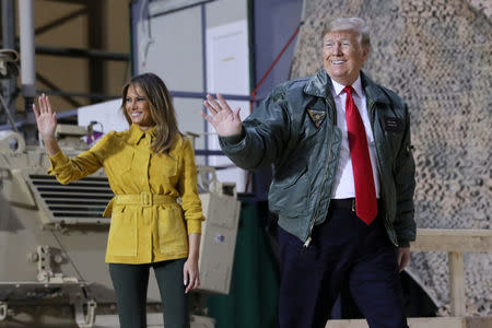 U.S. President Donald Trump, with first lady Melania Trump, arrives to deliver remarks to U.S. troops in an unannounced visit to Al Asad Air Base, Iraq, December 26, 2018. REUTERS/Jonathan Ernst