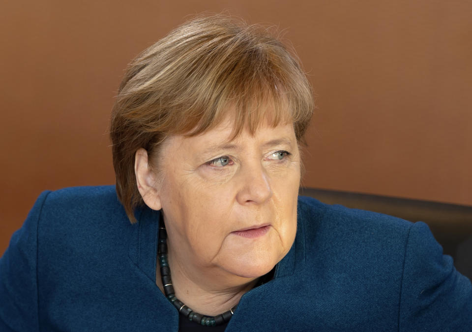 German Chancellor Angela Merkel arrives for the weekly cabinet meeting of the German government at the chancellery in Berlin, Germany, Wednesday, Feb. 5, 2020. (AP Photo/Jens Meyer)