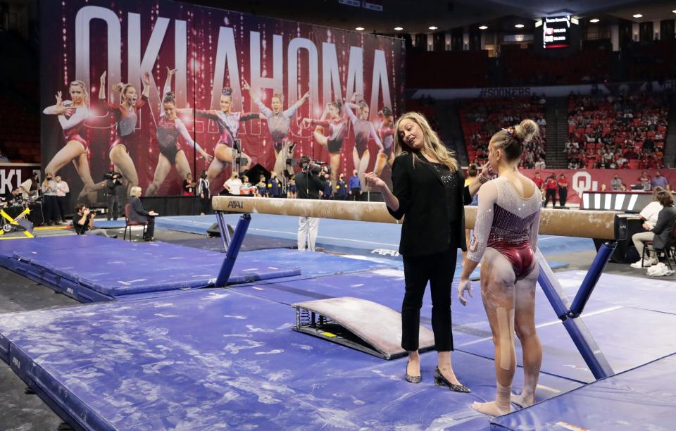 Head Coach K. J. Kindler calms Olivia Trautman before she competes on the beam as the University of Oklahoma women’s gymnastics team takes on the University of Michigan on Friday at the Lloyd Noble Center in Norman, Okla. [Steve Sisney/For The Oklahoman]