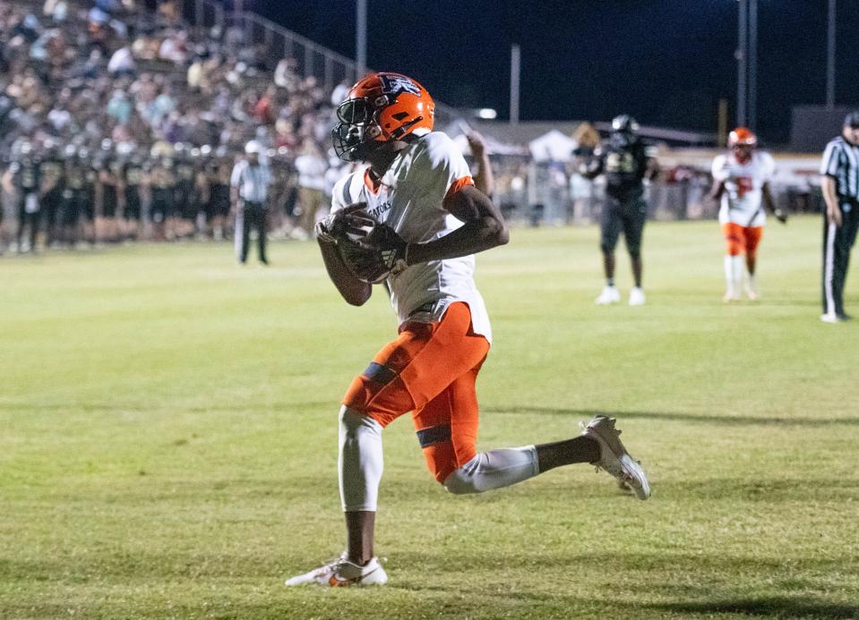 Ladarian Clardy (1) takes it in for a touchdown and a 20-0 Gators lead during the Escambia vs Milton football game at Milton High School on Friday, Sept. 22, 2023.