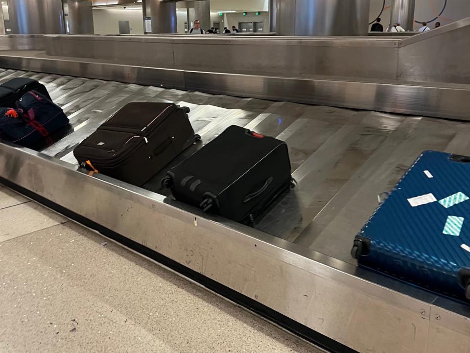 Baggage claim carousel with luggage.